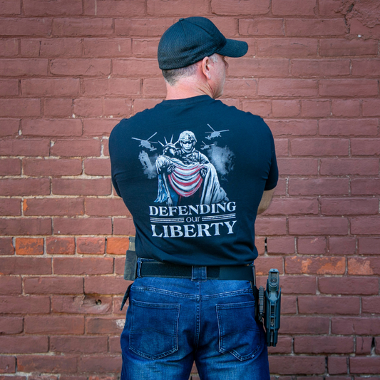 Defending Our Liberty shirt showing soldier carrying Lady Liberty artwork