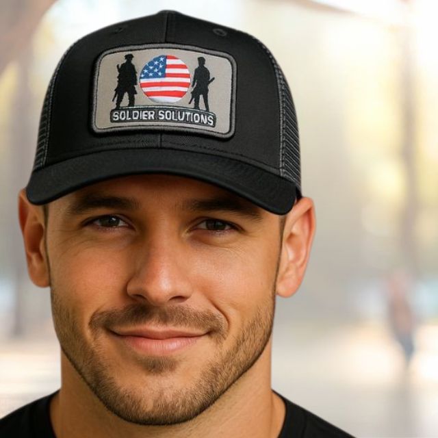 Man wearing black Soldier Solutions logo hat with curved brim and mesh back