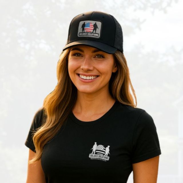 Woman wearing Soldier Solutions hat with embroidered patriotic patch and matching black logo t-shirt