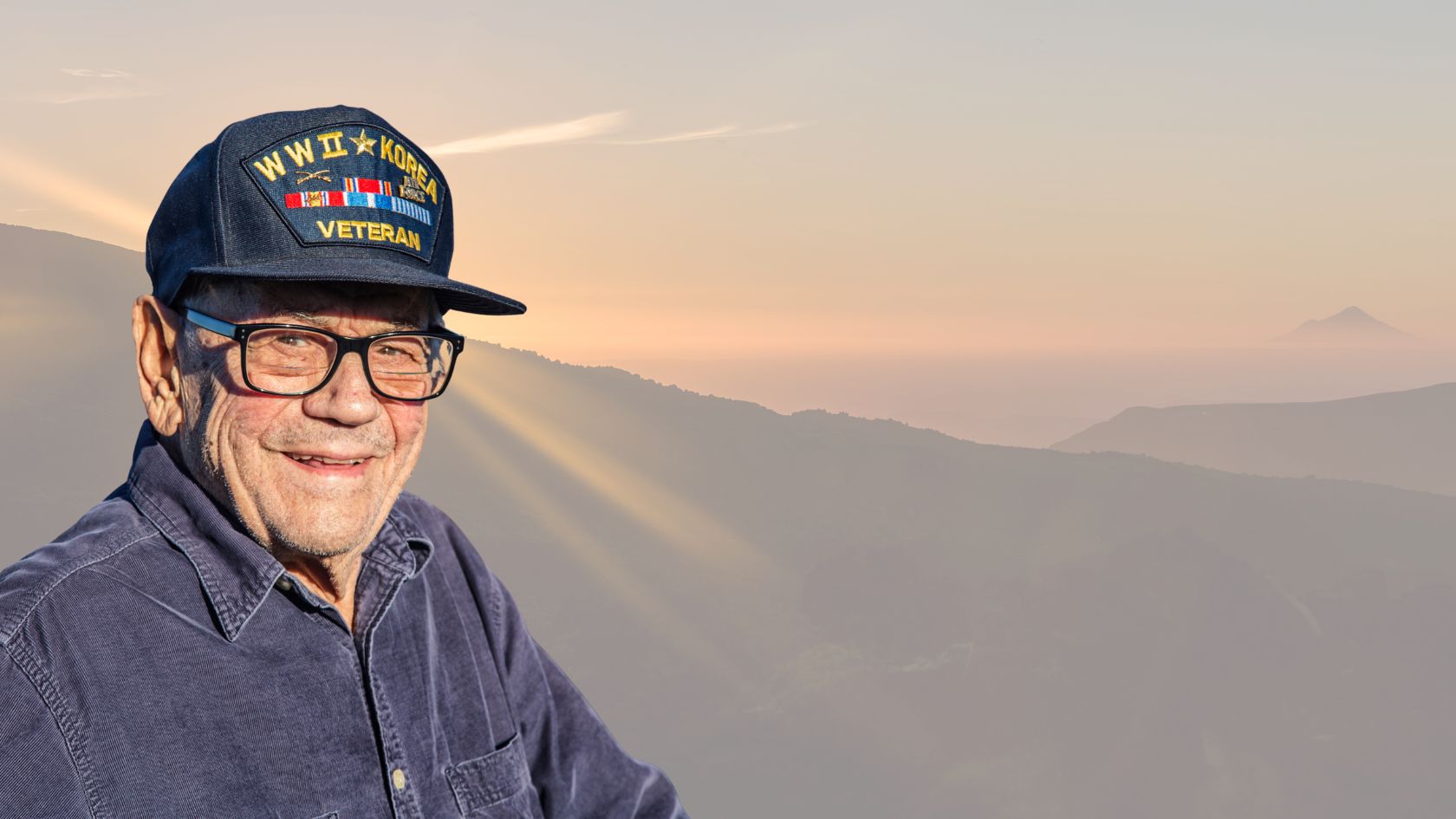 WWII and Korea veteran wearing a patriotic veteran hat and shirt, symbolizing pride and honoring Veterans Day in America.