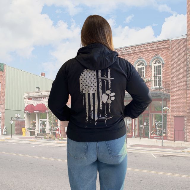 Women's American Companion hoodie with distressed American flag, heart line, and paw print graphic on back
