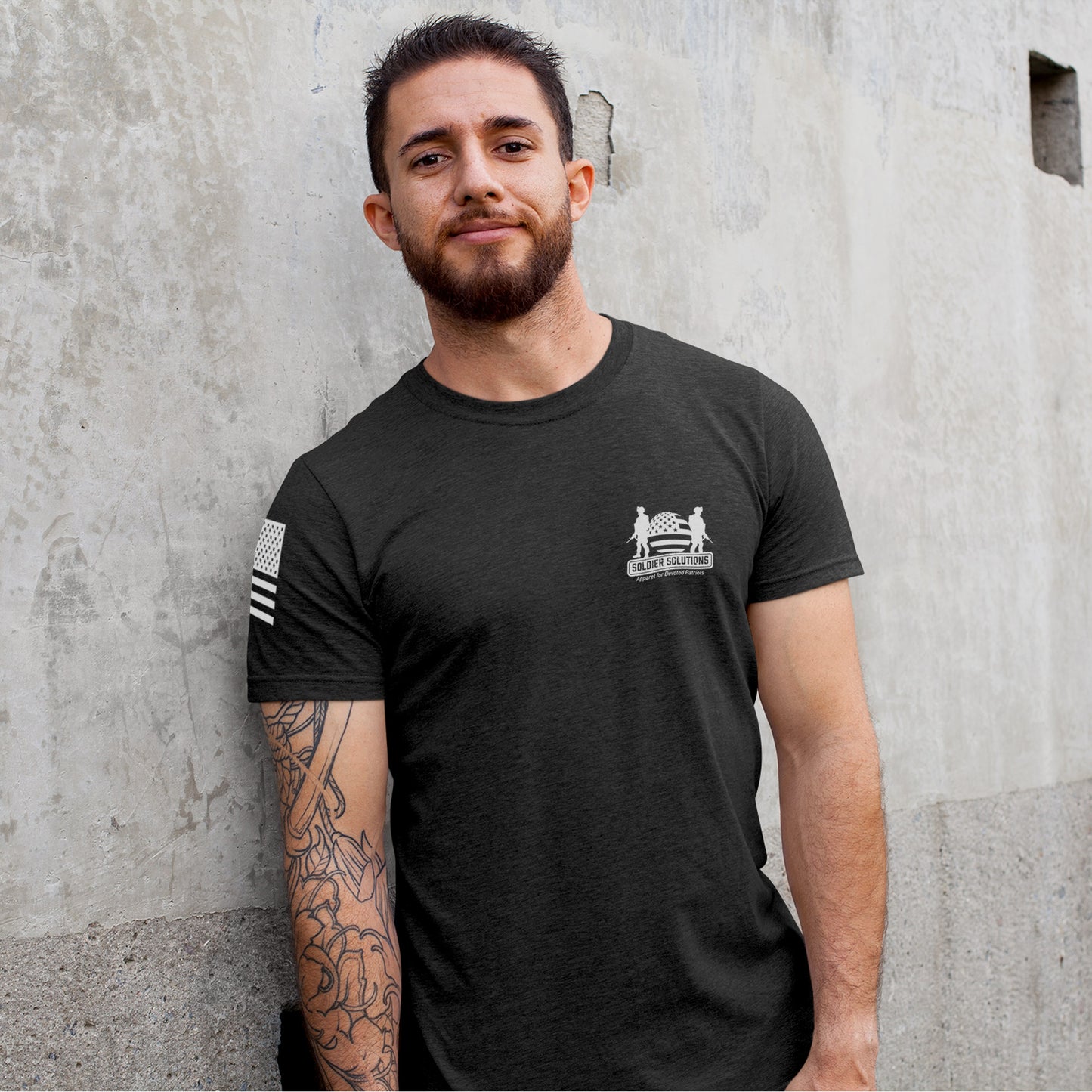 Man wearing Let Freedom Ring t-shirt by Soldier Solutions, front view showing Soldier Solutions chest logo and American flag sleeve graphic.