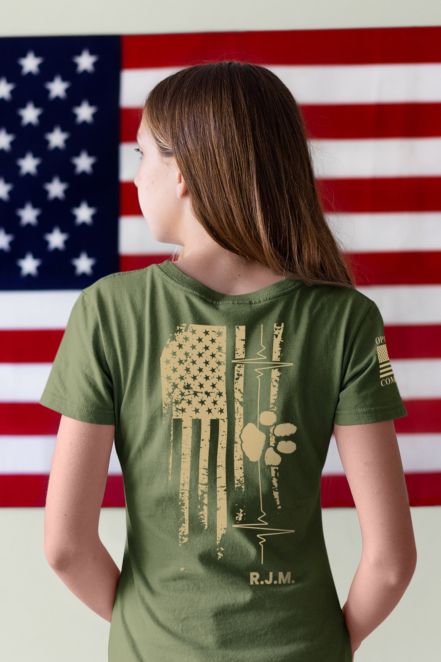 Full back view of American Companion t-shirt showing symbolic flag, heartbeat, and paw print with initials memorializing a fallen veteran.