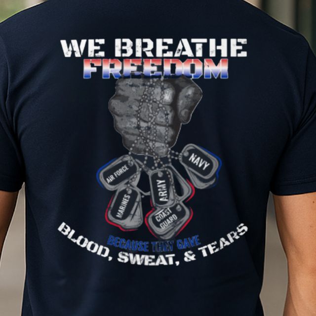 Close-up of We Breathe Freedom men’s patriotic shirt graphic with military fist and armed forces dog tags