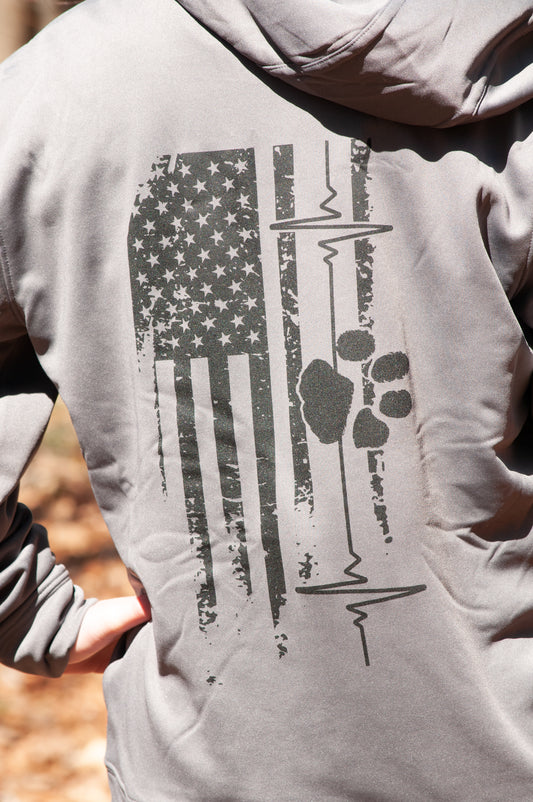 Close-up of American Companion hoodie back design featuring distressed American flag, heart line, and paw print