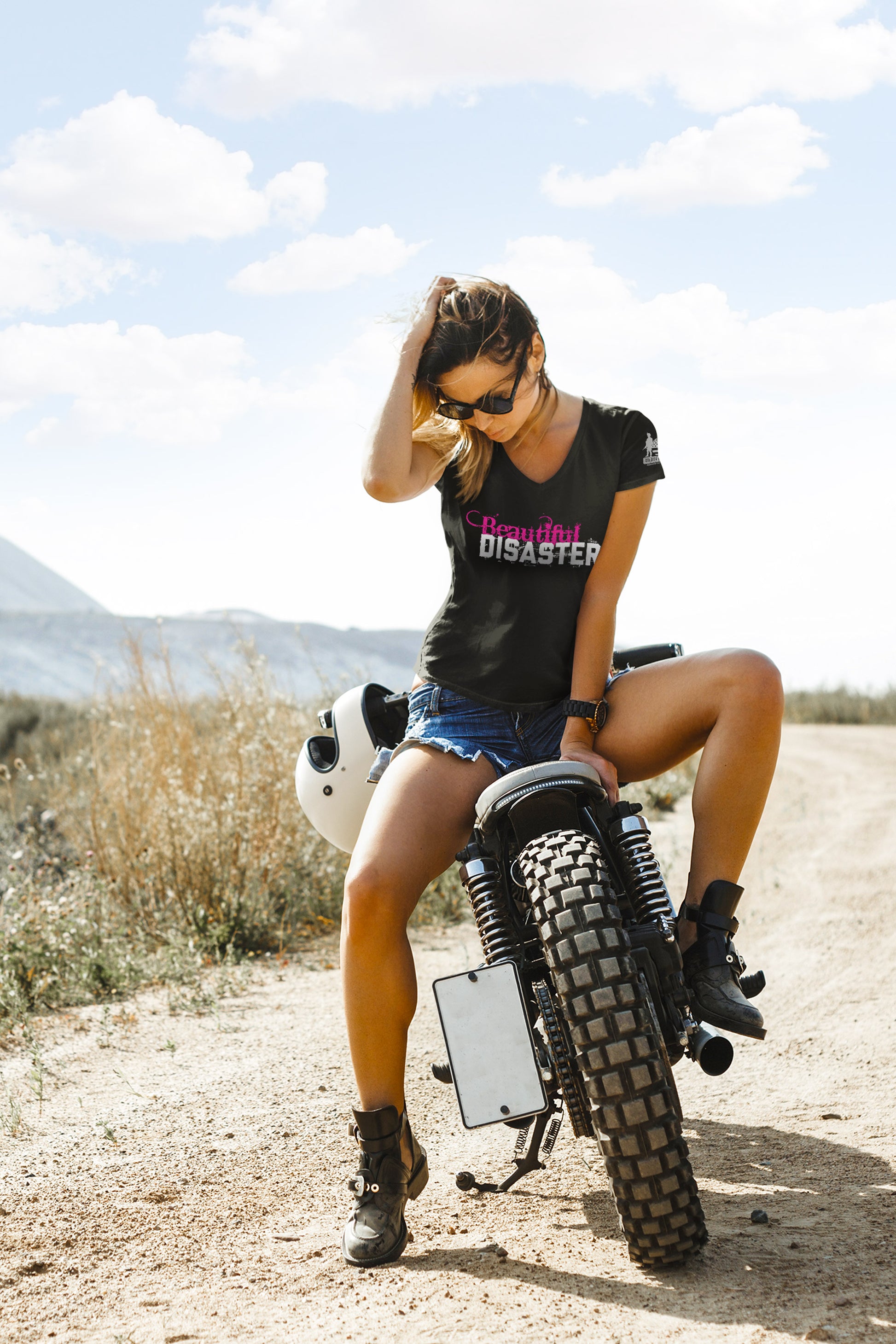 Woman wearing Beautiful Disaster tee from Soldier Solutions sitting on motorcycle