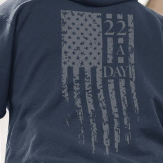 Close-up of men’s 22 A Day hoodie featuring distressed American flag and veteran suicide awareness message.