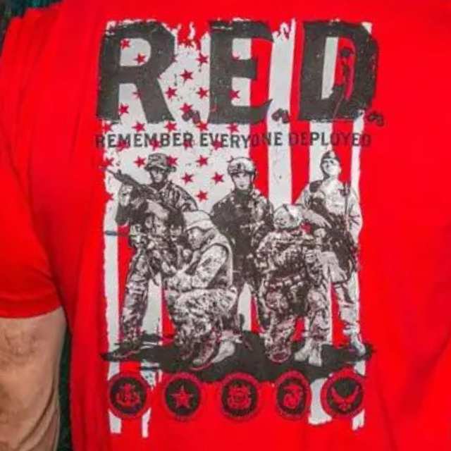 Close-up design on red R.E.D. shirt featuring deployed soldier imagery and armed service branch logos