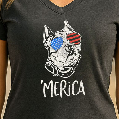 Close-up of patriotic dog in flag sunglasses with Merica slogan on women’s tee