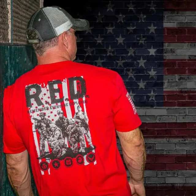Man wearing red R.E.D. shirt with military graphic and Remember Everyone Deployed print