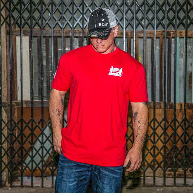 Man wearing R.E.D. shirt with Soldier Solutions logo on chest and Operation Companion patch on sleeve
