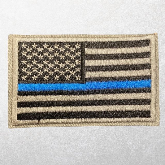 Thin Blue Line American flag patch with tan tactical border and hook backing