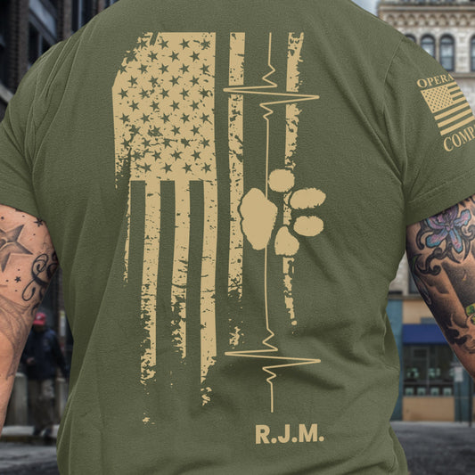 Back of men’s American Companion t-shirt with distressed flag, heartbeat line, paw print, and initials honoring a veteran lost to suicide.