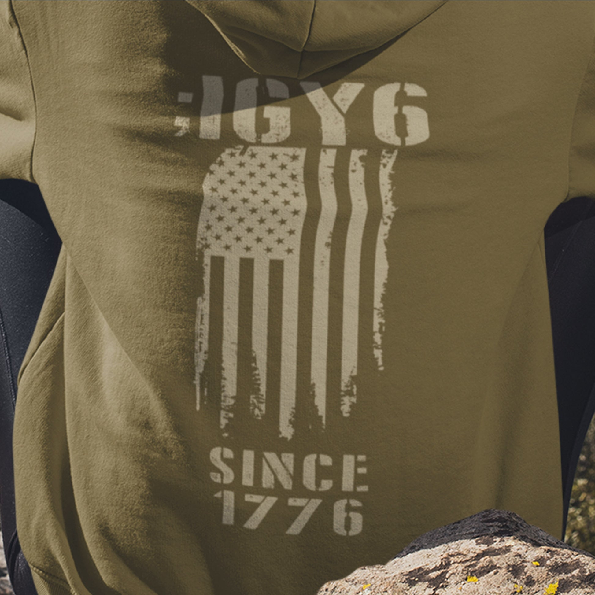 Close up of IGY6 Since 1776 women’s hoodie featuring distressed American flag and bold patriotic back print with sleeve insignia.