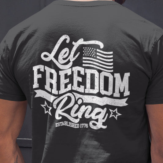Close up back of man wearing Let Freedom Ring t-shirt with bold distressed text ‘Let Freedom Ring – Established 1776’ and patriotic star details.