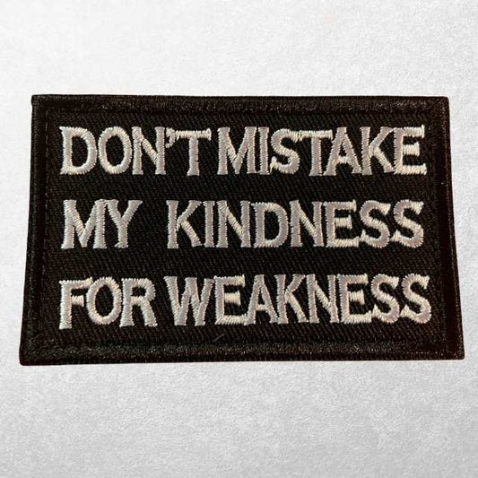 Black tactical patch with embroidered text "Don't Mistake My Kindness for Weakness"