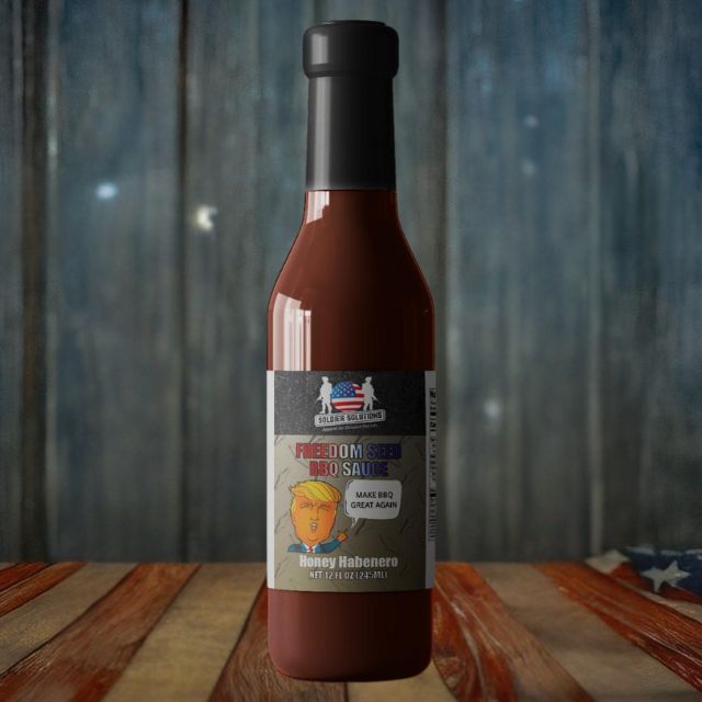 Honey habanero Freedom Seed BBQ Sauce bottle standing on rustic American-themed background