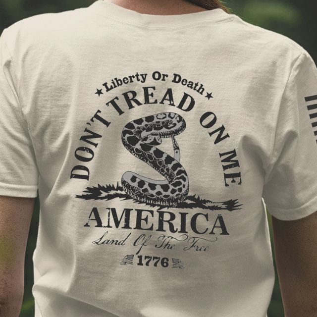Close up of the back of Don’t Tread on Me women’s shirt featuring coiled rattlesnake, Liberty or Death message, and 1776 graphic.