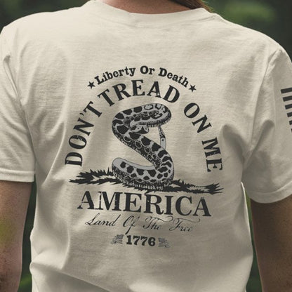 Close up of the back of Don’t Tread on Me women’s shirt featuring coiled rattlesnake, Liberty or Death message, and 1776 graphic.