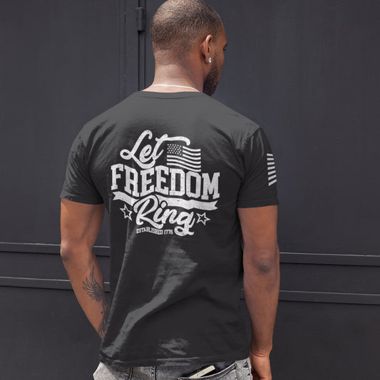 Back of man wearing Let Freedom Ring t-shirt with bold distressed text ‘Let Freedom Ring – Established 1776’ and patriotic star details.