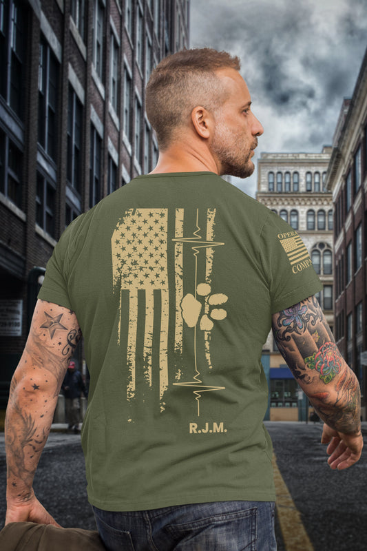 Full back view of men’s tribute t-shirt featuring American flag, heartbeat, paw print, and R.J.M. initials in honor of a fallen veteran.