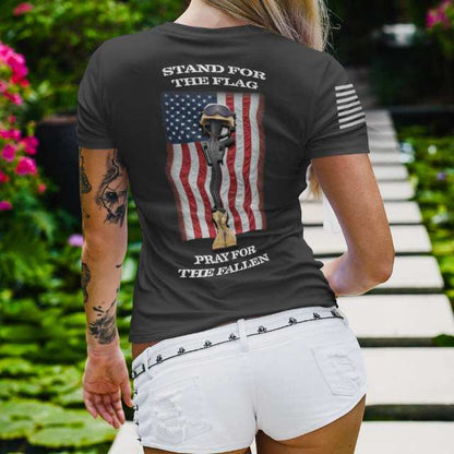 Back view of women's t-shirt with distressed American flag and battlefield cross reading "Stand for the Flag, Pray for the Fallen"