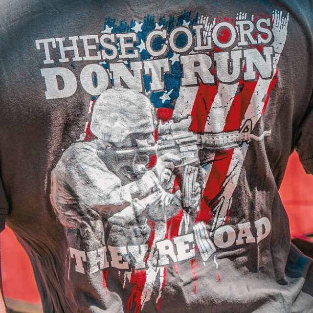 Close-up of rifleman and distressed American flag design on patriotic women’s t-shirt with reload message