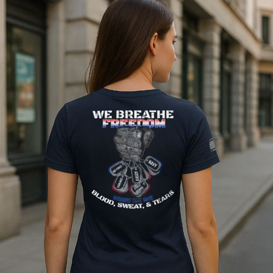 Woman wearing We Breathe Freedom women’s patriotic t-shirt showing back graphic with military dog tags and raised fist