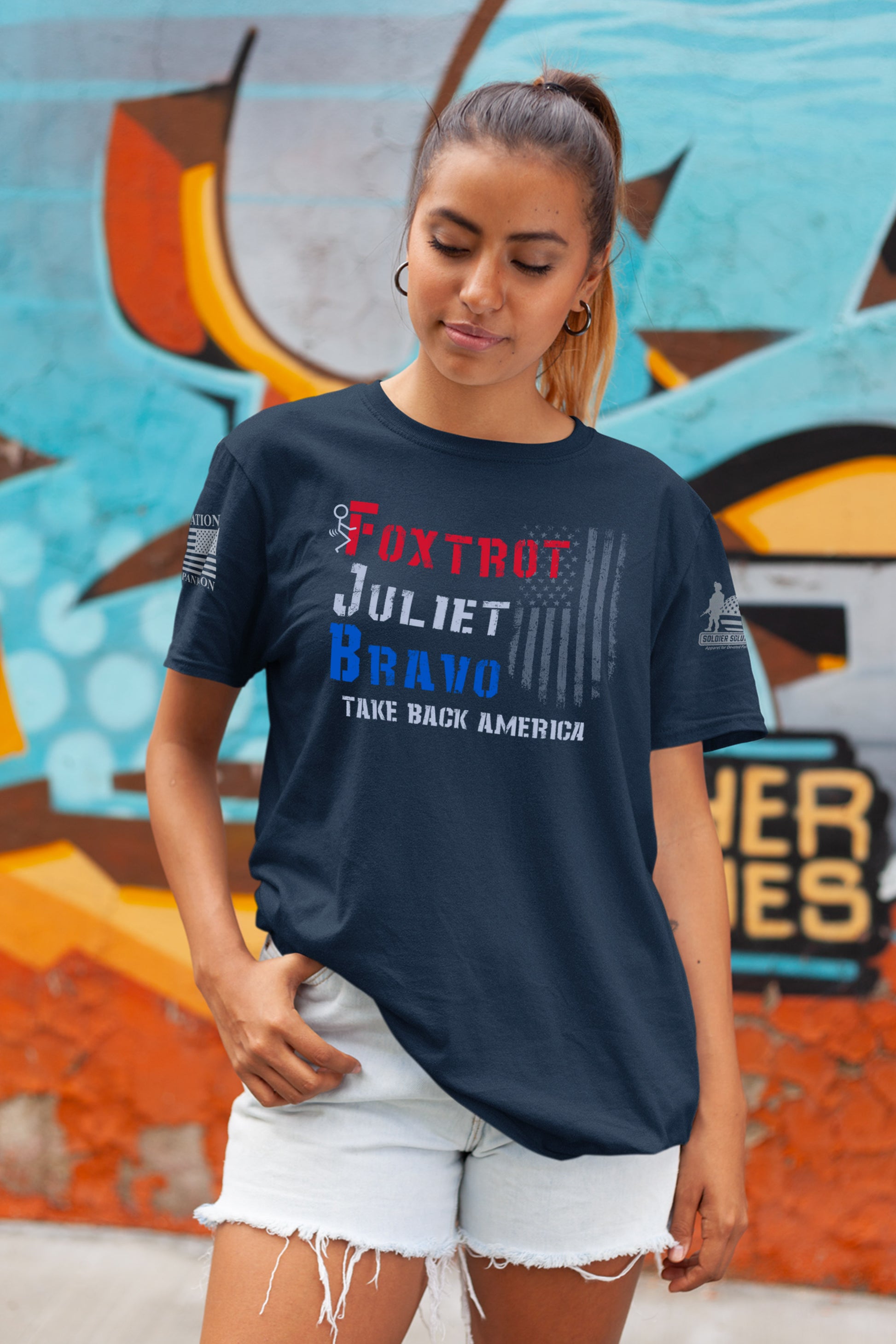 Women’s bold message shirt featuring Foxtrot Juliet Bravo stencil-style print and flag.