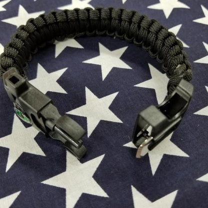 Camo 550 paracord survival bracelet with compass, fire starter, and whistle for outdoor adventure.