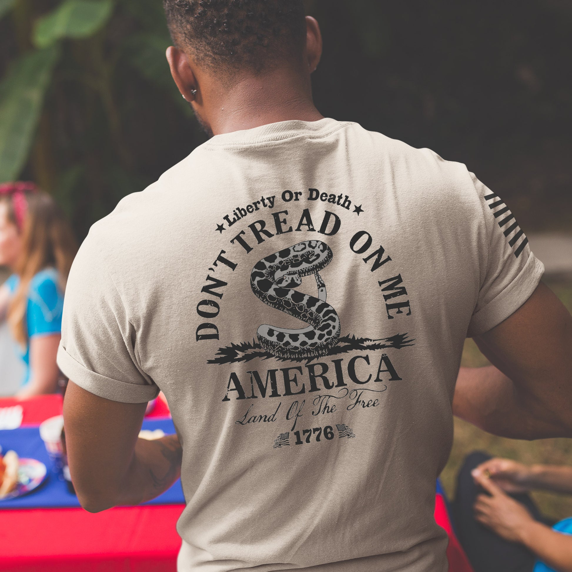 Close up of the back of Don’t Tread on Me shirt with Gadsden flag rattlesnake, Liberty or Death message, and 1776 founding date.