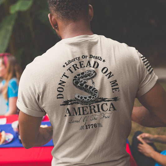 Close up of the back of Don’t Tread on Me shirt with Gadsden flag rattlesnake, Liberty or Death message, and 1776 founding date.