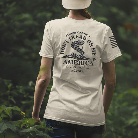 Back of Don’t Tread on Me women’s shirt featuring coiled rattlesnake, Liberty or Death message, and 1776 graphic.